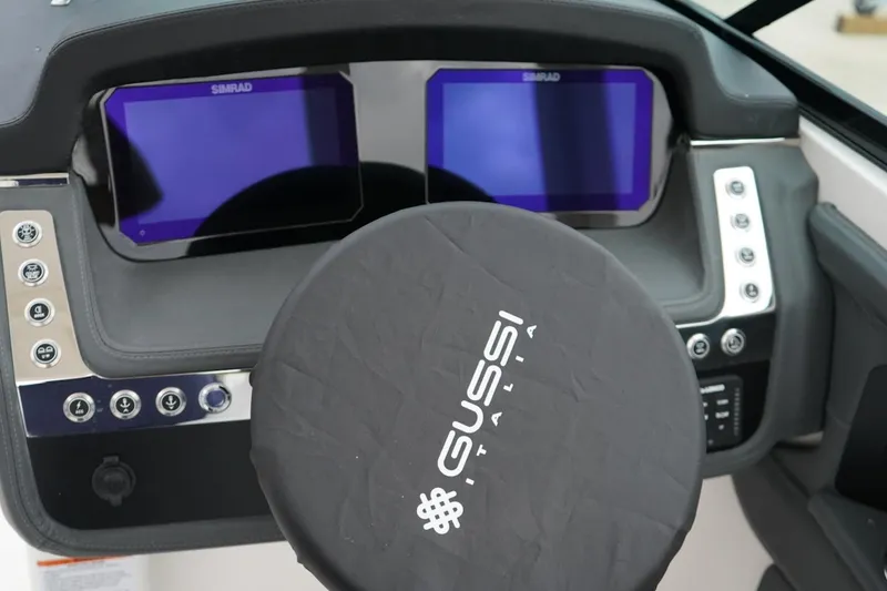 Slide: The Image of Dashboard of 2026 Chaparral 270 OSX boat with dual Simrad displays and Gussi Italia steering. - 16