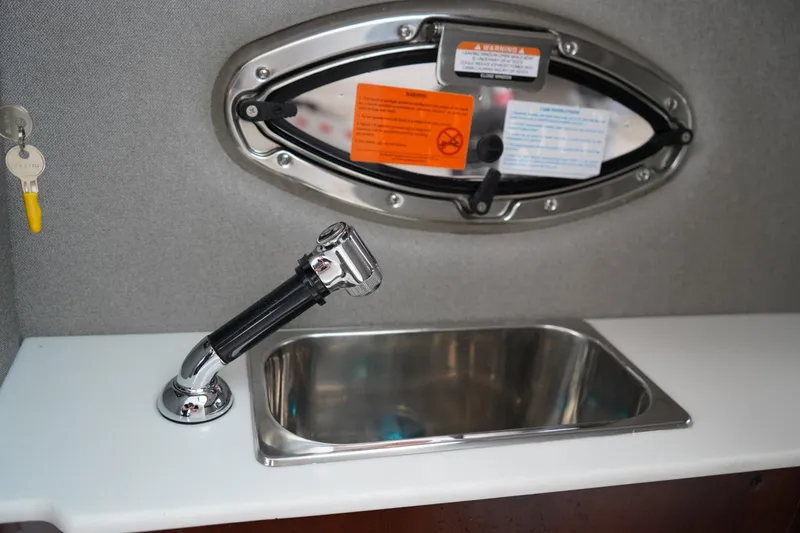 Slide: The Image of Chaparral 270 OSX 2026 boat interior with sink and faucet detail. - 20