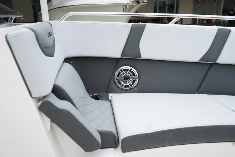 Slide: The Image of 2026 Chaparral 270 OSX boat interior with sleek seating and built-in speaker. - 25
