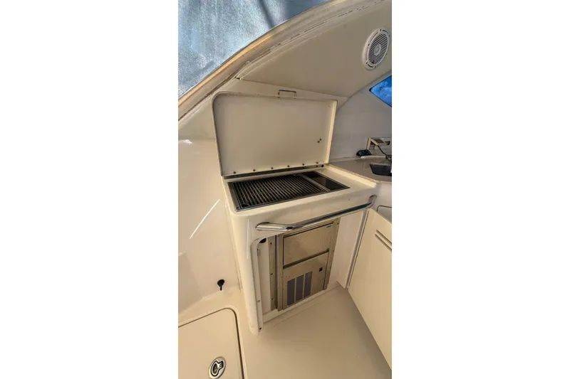 Slide: The Image of 2010 Sea Ray 470 Sundancer yacht interior with built-in grill and storage. - 13