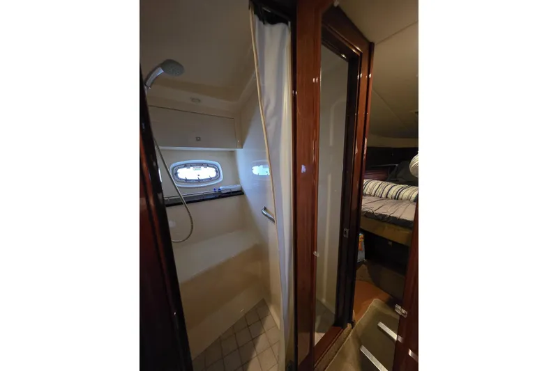 Slide: The Image of 2010 Sea Ray 470 Sundancer interior with shower and cozy bedroom. - 4