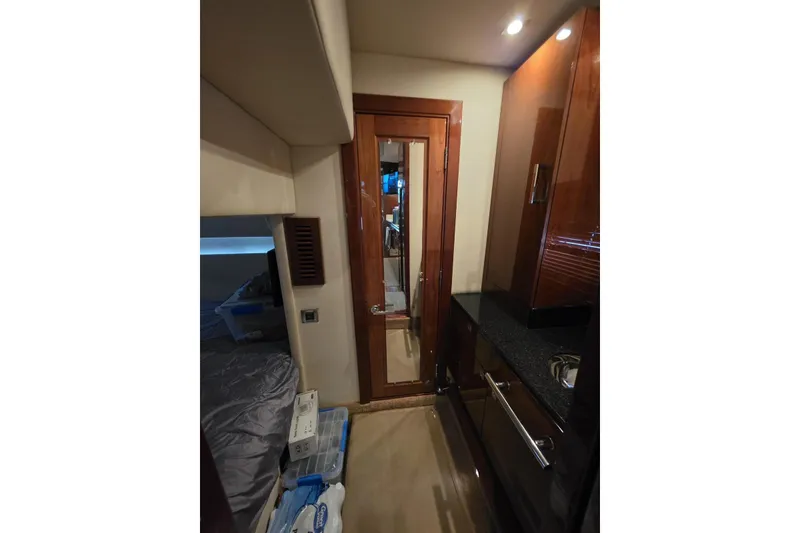 Slide: The Image of Interior of 2010 Sea Ray 470 Sundancer yacht, featuring a sleek wooden door and modern cabinetry. - 8