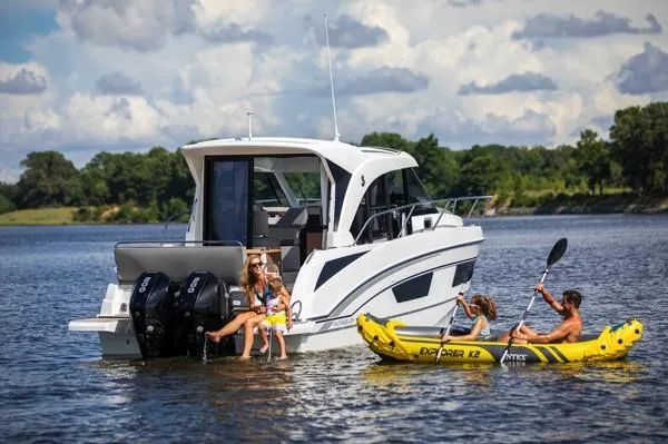 Slide: The Image of 2024 Beneteau Antares 9 on a lake with people kayaking nearby. - 5