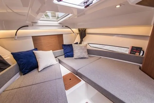 Slide: The Image of Interior cabin of 2024 Beneteau Antares 9 with cozy seating and pillows. - 14