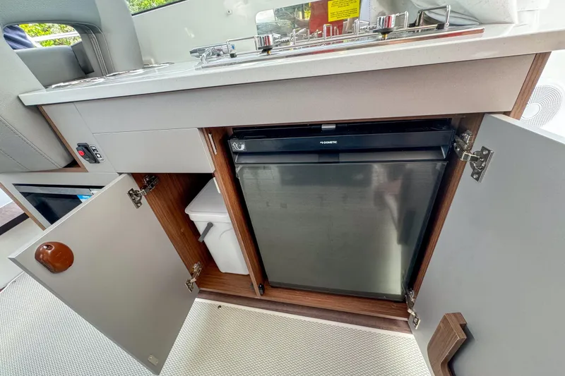 Slide: The Image of Interior view of 2026 Beneteau Antares 9 kitchen with fridge and storage. - 20