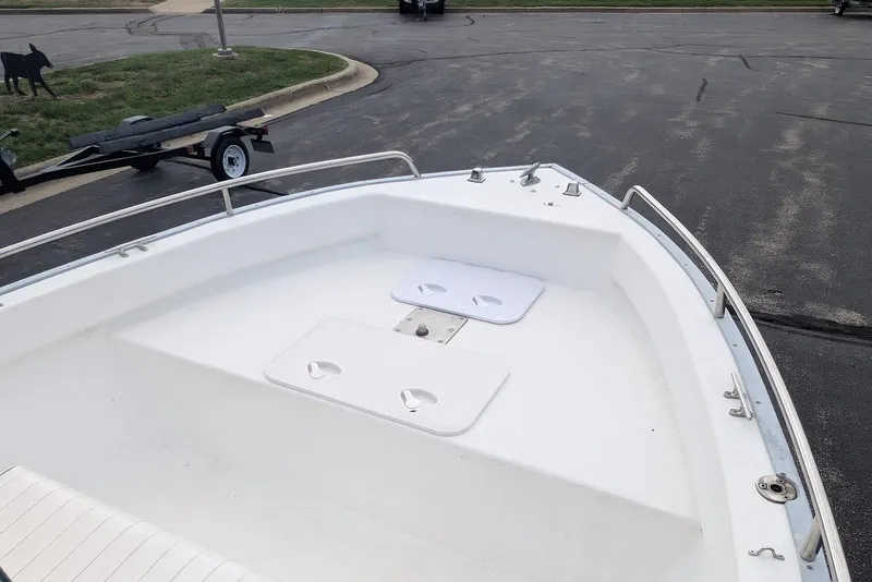 Slide: The Image of 1999 Cape Horn 17' Center Console boat with white deck and railing in parking lot. - 11