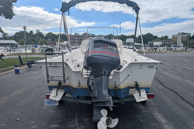 Slide: The Image of 1999 Cape Horn 17' Center Console boat with Yamaha V4 115 outboard motor in a marina. - 3