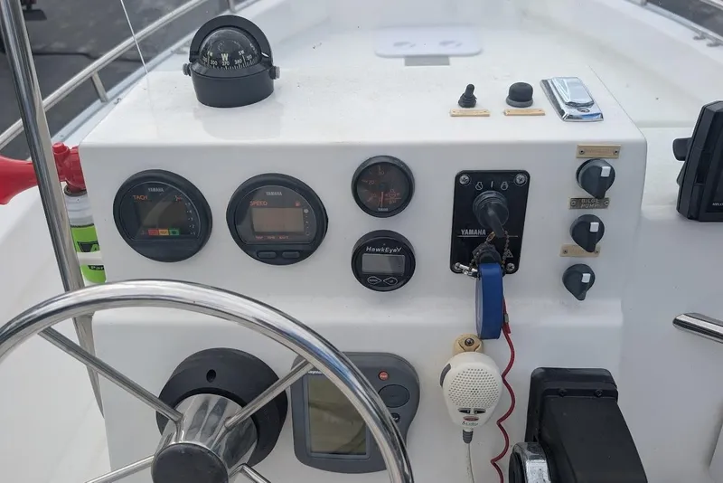 Slide: The Image of 1999 Cape Horn 17' Center Console boat dashboard with steering wheel and navigation instruments. - 15
