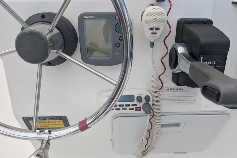 Slide: The Image of 1999 Cape Horn 17' Center Console dashboard with steering wheel, controls, and electronics. - 18