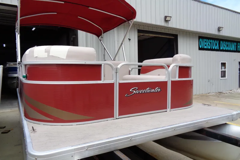 Slide: The Image of Red 2014 Sweetwater 2086 DFS pontoon boat at a dealership. - 4