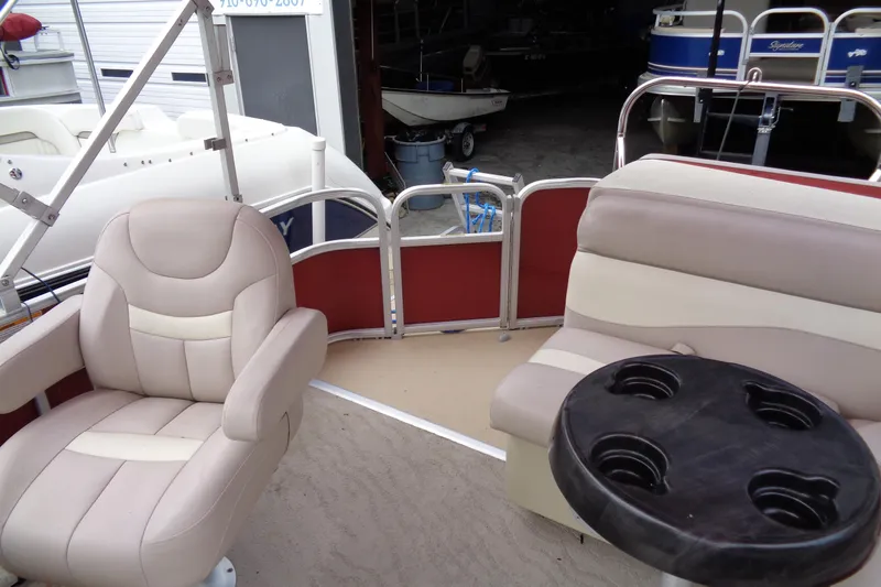 Slide: The Image of Interior of a 2014 Sweetwater 2086 DFS pontoon boat with beige seating and cup holders. - 8