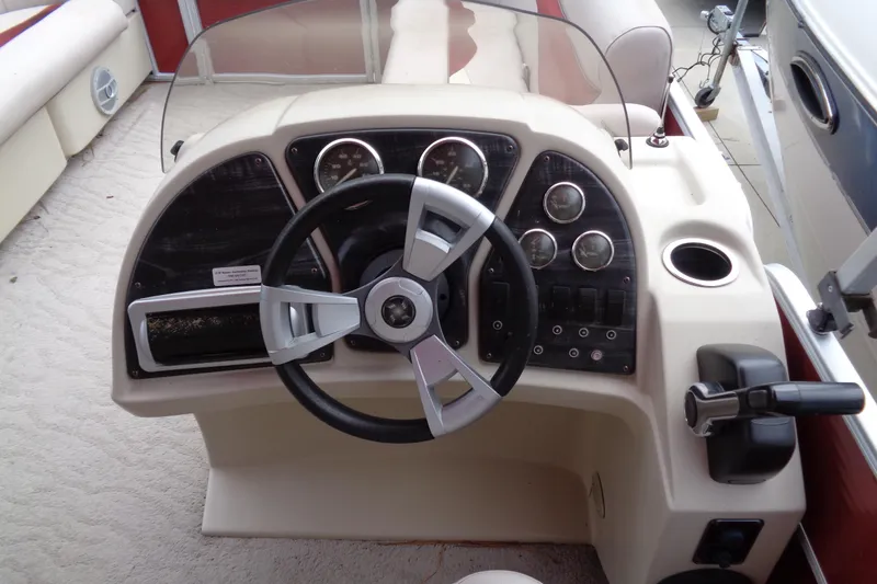 Slide: The Image of Steering console of a 2014 Sweetwater 2086 DFS boat with gauges and controls. - 9