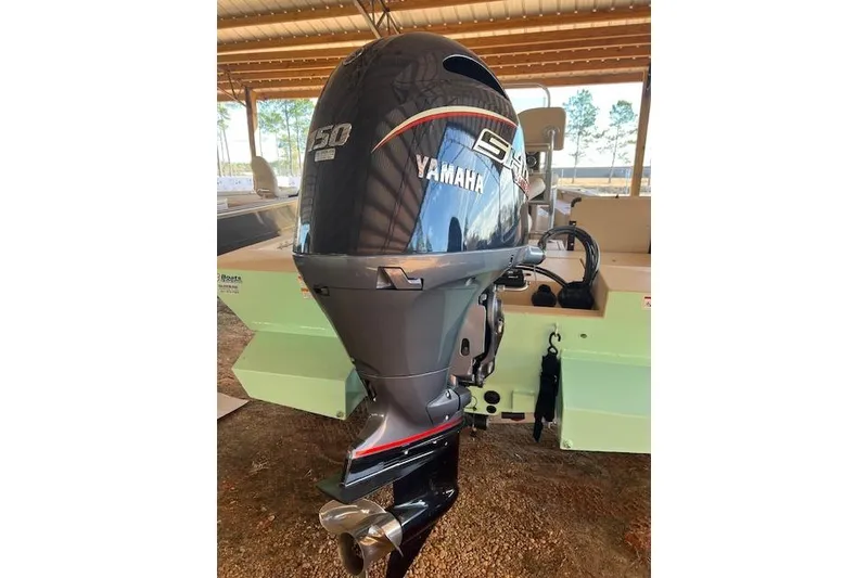 Slide: The Image of 2024 G3 Bay 20 GX boat with Yamaha 50 outboard motor in a covered area. - 5