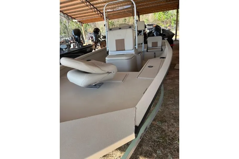 Slide: The Image of 2024 G3 Bay 20 GX boat with beige seating under a canopy. - 8