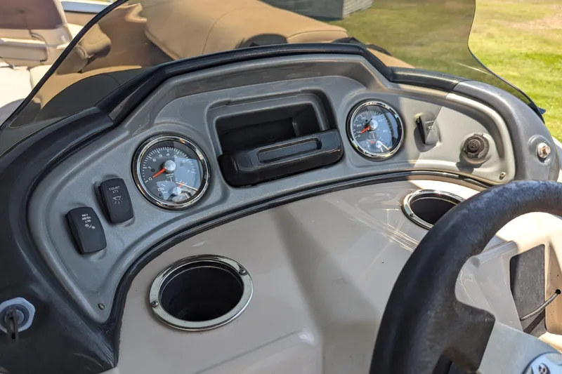 Slide: The Image of 2019 Sun Tracker Fishin' Barge 24 DLX dashboard with gauges and controls. - 13