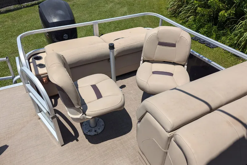 Slide: The Image of 2019 Sun Tracker Fishin' Barge 24 DLX interior with beige seating and railing. - 14