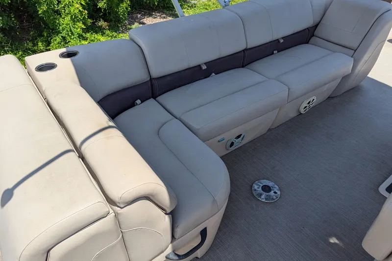 Slide: The Image of 2019 Sun Tracker Fishin' Barge 24 DLX interior seating with cup holders and speakers. - 16
