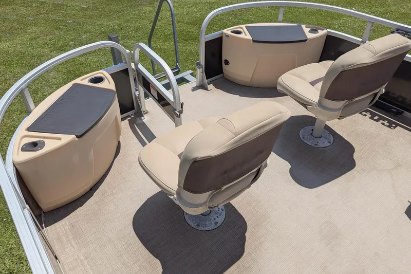 Slide: The Image of 2019 Sun Tracker Fishin' Barge 24 DLX interior with seating and storage compartments. - 6