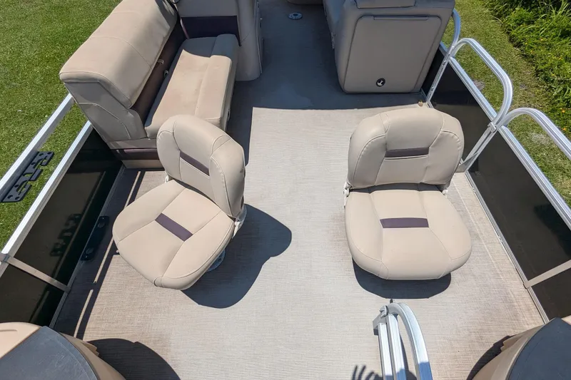 Slide: The Image of 2019 Sun Tracker Fishin' Barge 24 DLX interior with beige seating and spacious layout. - 7