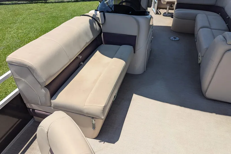 Slide: The Image of 2019 Sun Tracker Fishin' Barge 24 DLX interior with beige seating and spacious layout. - 8