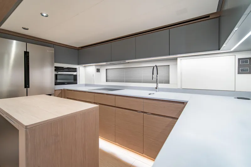 Slide: The Image of Luxurious interior of 2027 Pardo Yachts GT75, featuring modern kitchen and elegant seating area. - 32
