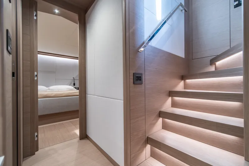 Slide: The Image of Luxurious interior of 2027 Pardo Yachts GT75, featuring modern staircase and cozy bedroom. - 58