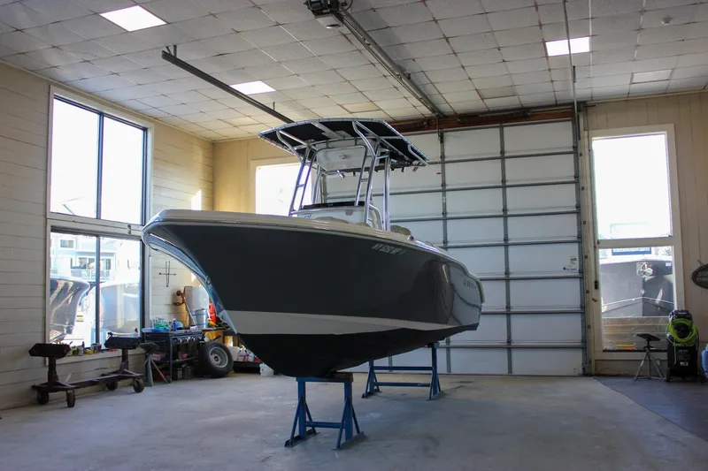 Slide: The Image of 2018 Key West 219 FS boat in a garage, elevated on stands. - 11