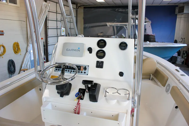 Slide: The Image of 2018 Key West 219 FS boat console with Garmin navigation system in a showroom. - 16