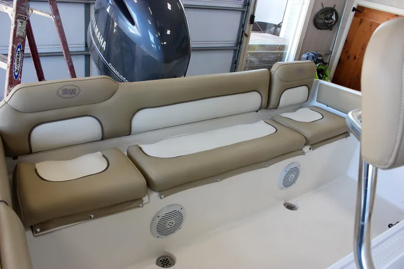 Slide: The Image of 2018 Key West 219 FS boat interior with beige seating and Yamaha engine. - 18