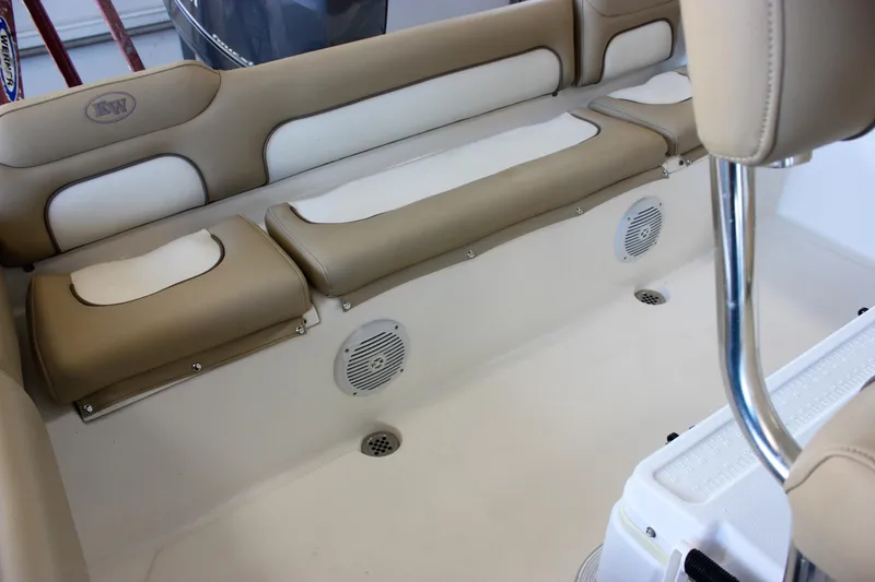 Slide: The Image of 2018 Key West 219 FS boat interior with beige seating and built-in speakers. - 21