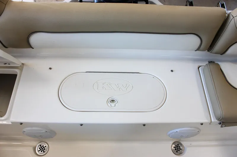 Slide: The Image of 2018 Key West 219 FS boat interior with beige seating and storage compartment. - 22