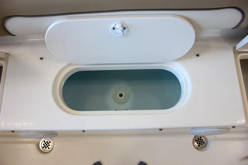 Slide: The Image of Livewell compartment on a 2018 Key West 219 FS boat, open lid view. - 25