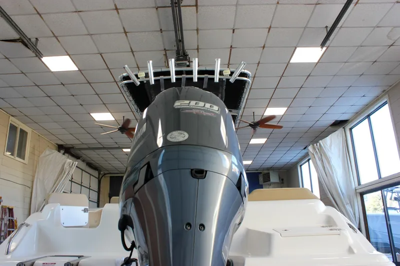 Slide: The Image of 2018 Key West 219 FS boat with powerful outboard motor in indoor storage. - 3