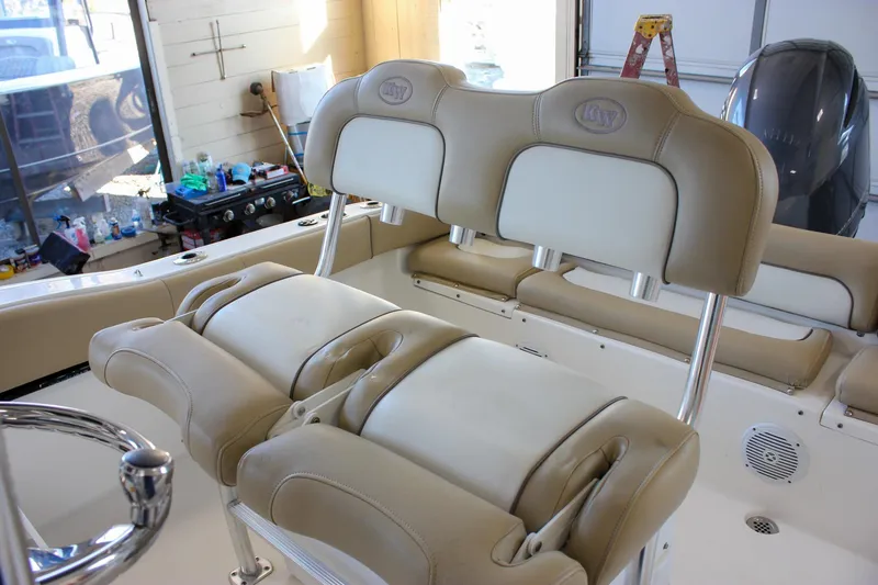 Slide: The Image of 2018 Key West 219 FS boat interior with beige seating and stainless steel fixtures. - 32
