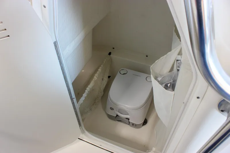 Slide: The Image of 2018 Key West 219 FS boat interior with compact marine toilet. - 42