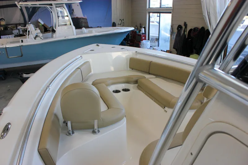 Slide: The Image of 2018 Key West 219 FS boat interior with beige seating in a garage setting. - 43