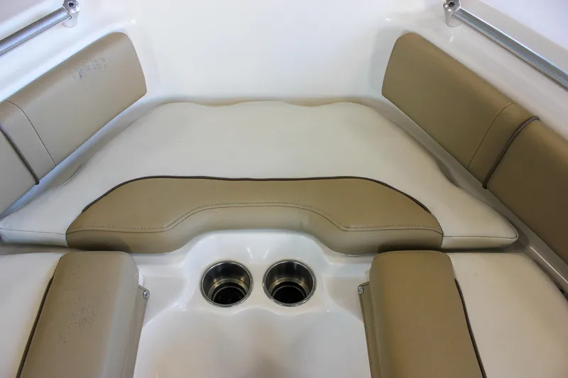 Slide: The Image of 2018 Key West 219 FS boat interior with tan cushioned seating and dual cup holders. - 46