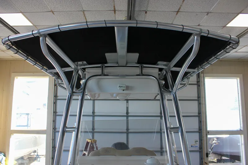 Slide: The Image of 2018 Key West 219 FS boat T-top in a garage setting. - 47