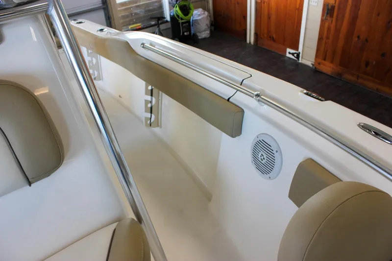 Slide: The Image of 2018 Key West 219 FS boat interior with beige seating and speaker detail. - 49