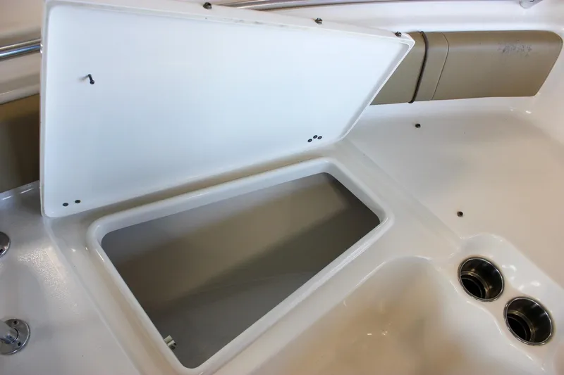 Slide: The Image of Open storage compartment on 2018 Key West 219 FS boat with cup holders. - 52