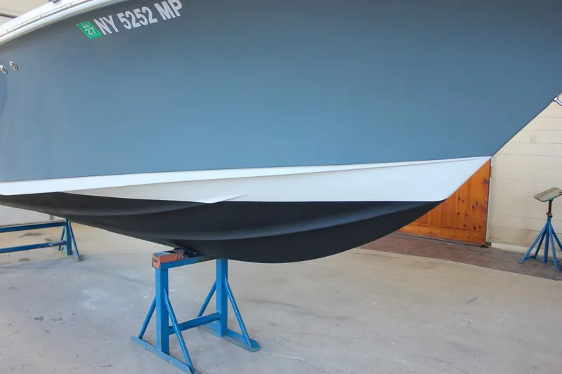 Slide: The Image of 2018 Key West 219 FS boat on stands in a garage. - 58