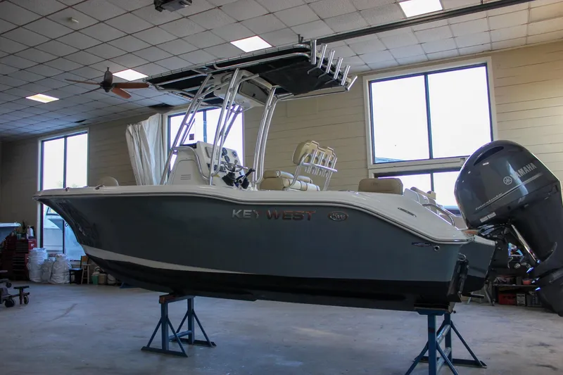 Slide: The Image of 2018 Key West 219 FS boat in indoor storage with Yamaha outboard motor. - 59