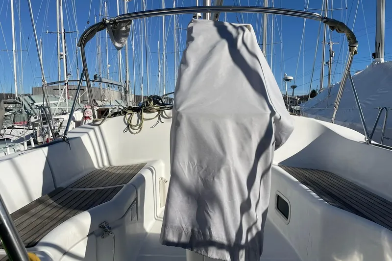 Slide: The Image of Beneteau Oceanis 361 sailboat cockpit, 2000 model, with covered helm and marina background. - 6