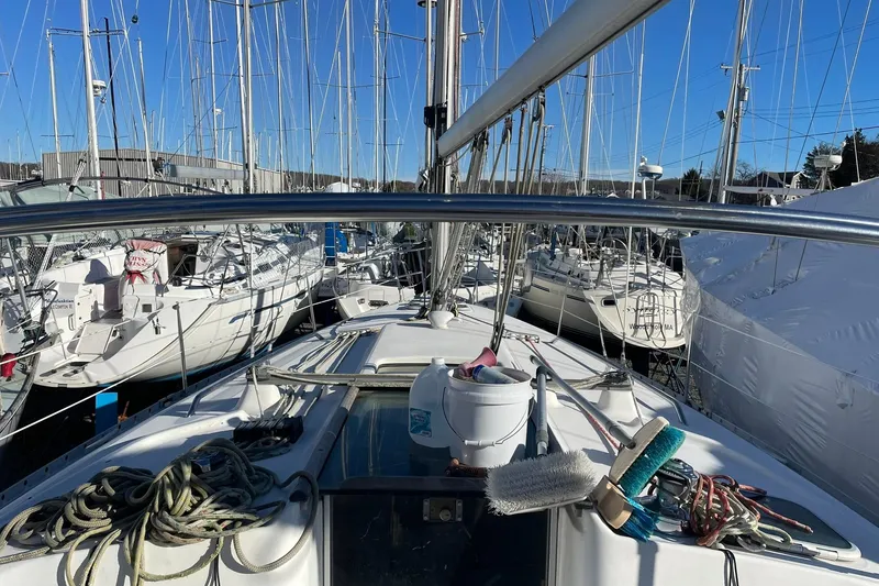 Slide: The Image of Beneteau Oceanis 361 sailboat from 2000 docked among other boats in a marina. - 16