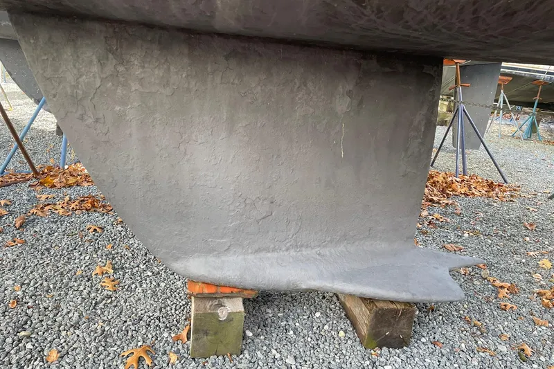 Slide: The Image of Keel of 2000 Beneteau Oceanis 361 sailboat on stands, surrounded by autumn leaves. - 10