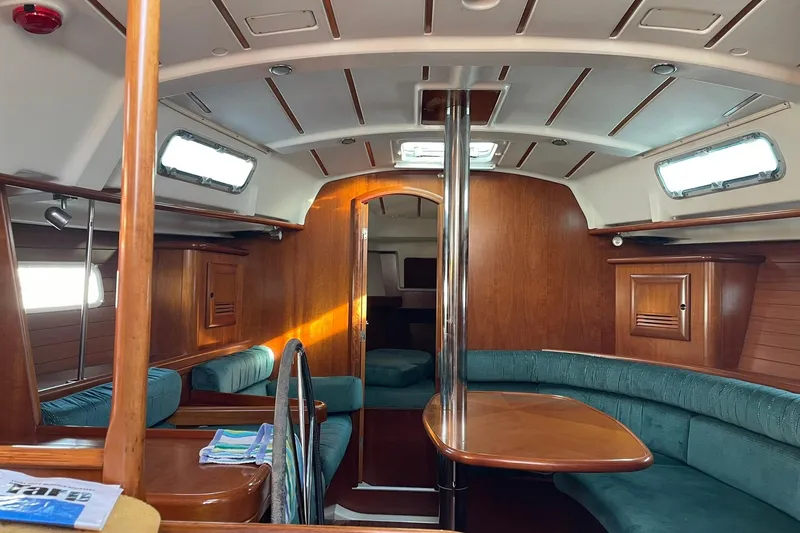 Slide: The Image of Interior of 2000 Beneteau Oceanis 361 sailboat with wood finish and teal seating. - 17
