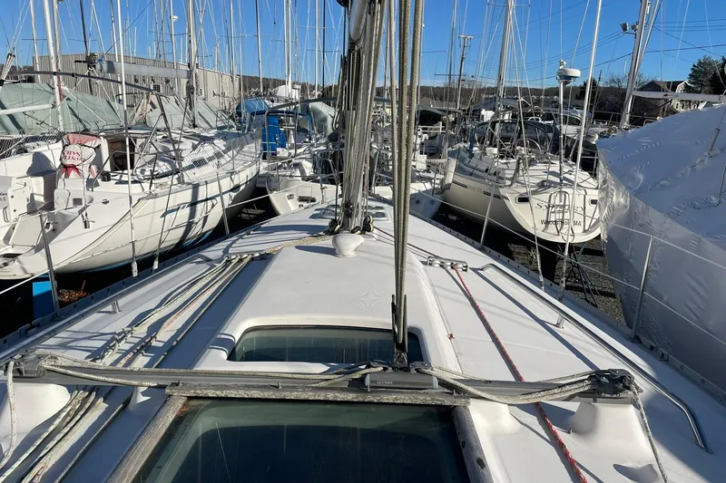 Slide: The Image of 2000 Beneteau Oceanis 361 sailboat docked among other yachts in a marina. - 2