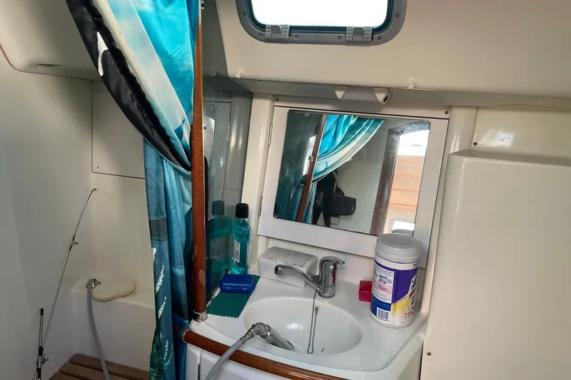 Slide: The Image of Beneteau Oceanis 361 bathroom interior with sink, mirror, and toiletries, 2000 model. - 21