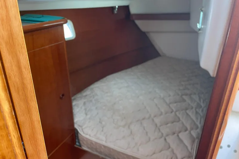 Slide: The Image of Cozy cabin interior of 2000 Beneteau Oceanis 361 sailboat with wooden finish and mattress. - 25