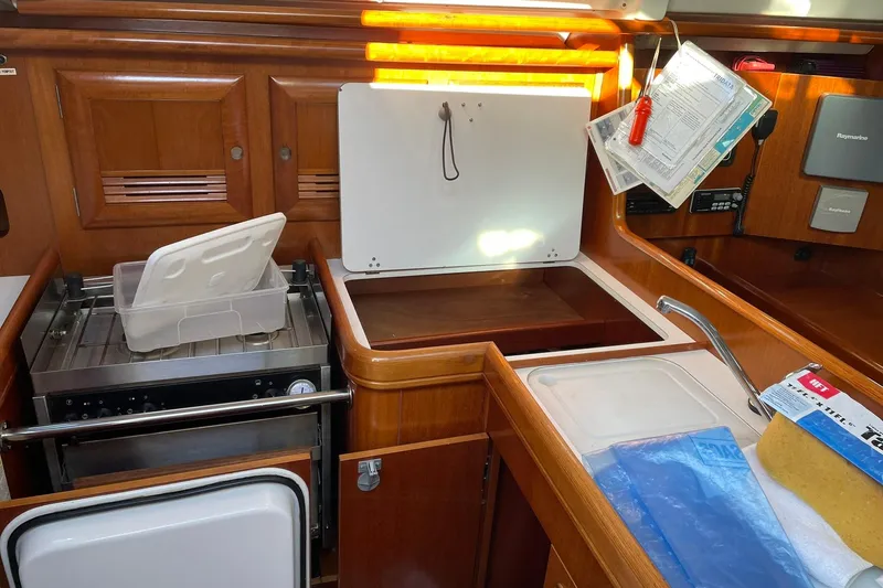 Slide: The Image of Interior of 2000 Beneteau Oceanis 361 yacht kitchen with wooden cabinetry and appliances. - 28